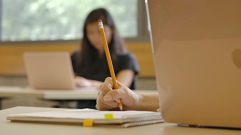 laptop and notepad in classroom