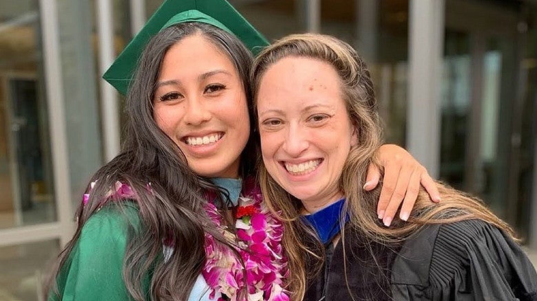 student and faculty member on graduation day