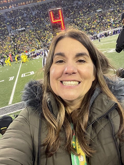 image of Jen Doty, PhD facing camera taken at a UO Ducks football game