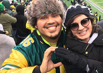 image of UO alumni Bryan Rojas-Arauz at a UO football game with friends