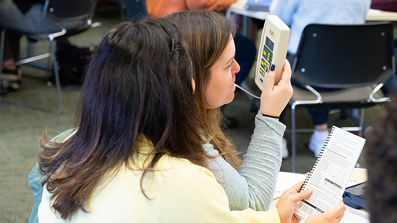 students in CDS classroom using testing equipment