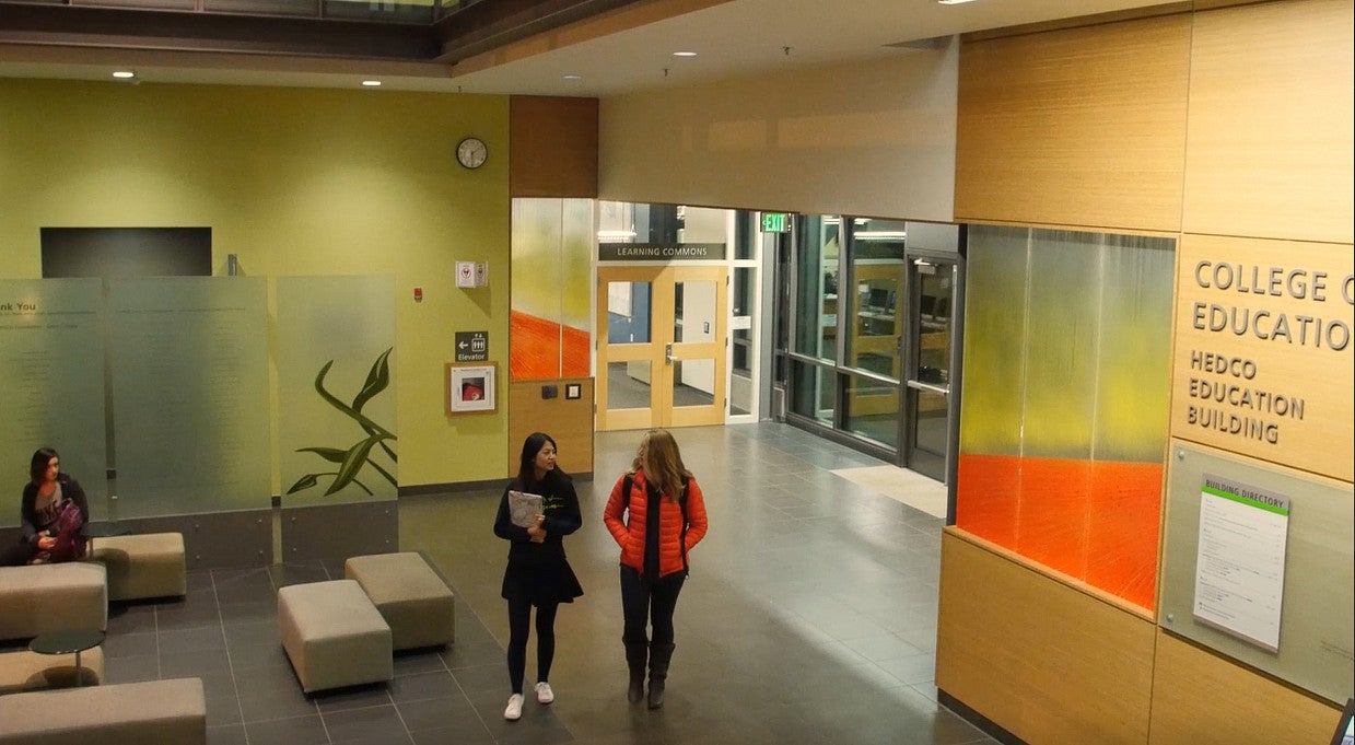 image of students walking and talking through HEDCO lobby