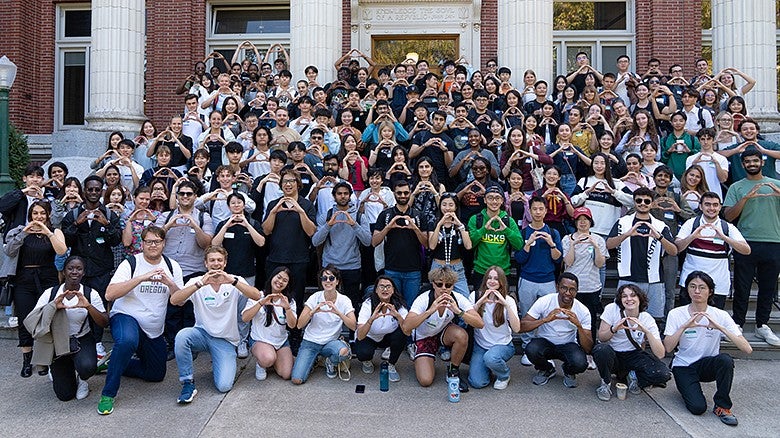 image of UO international students throwing the Oregon O