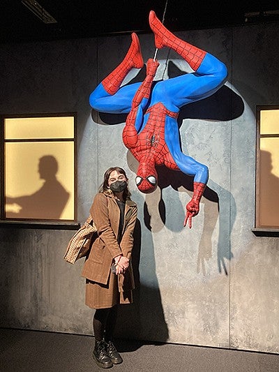 image of T. Acosta standing next to Marvel's Spider Man