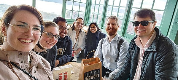 Sarah Quinn with other individuals sitting at a table