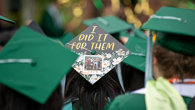 graduate wearing a cap that says I did it for them