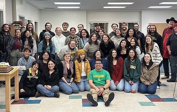 Ricardo Silas and group of students facing the camera and smiling