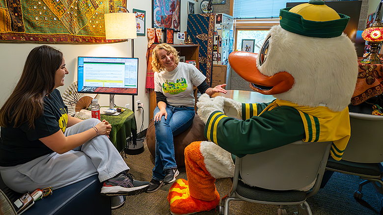 Oregon Duck with advisor and student sitting in conference