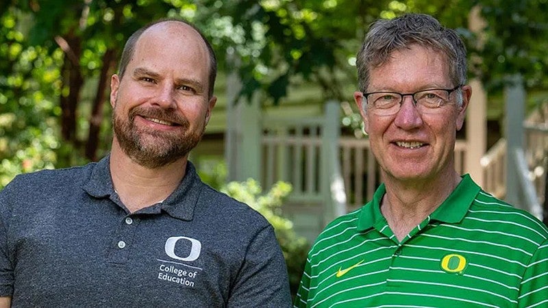 Kent McIntosh and Bob Mighell facing camera smiling