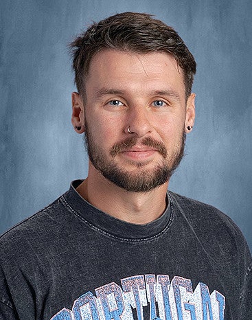 Alex Walker headshot with blue background