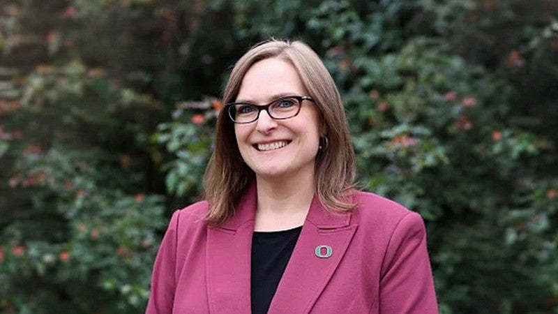 College of Education Dean Emily Tanner-Smith PhD in pink jacket smiling at camera