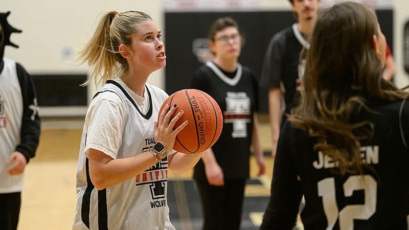 Sophie Flicker (middle) prepares to make a pass during a Unified basketball game at Tualatin High School. (Photo courtesy Christopher Germano)