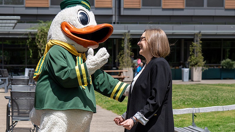 the Oregon Duck mascot with COE Dean Emily Tanner-Smith
