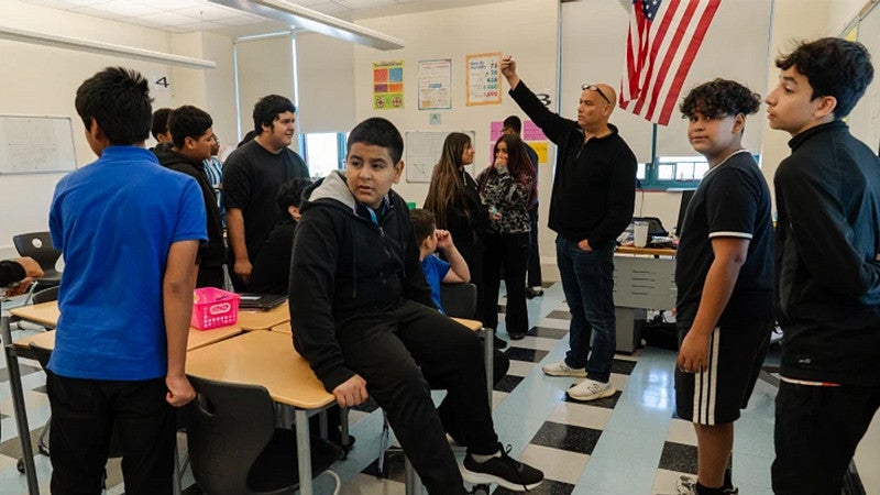 group of English learning students in a classroom with a teacher