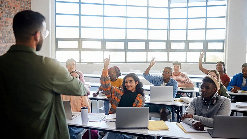 teacher standing in a classroom filled with adult students