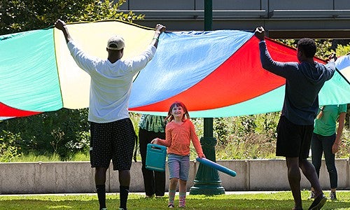 University of Oregon College of Education students playing with children