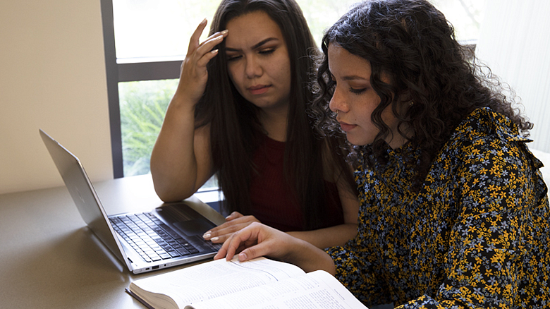two students working on a laptop in HEDCO Learning Commons