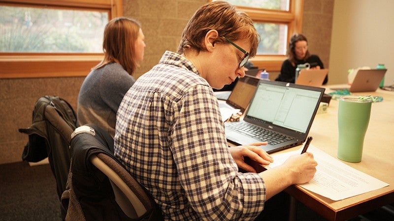 University of Oregon College of Education student at table in study group