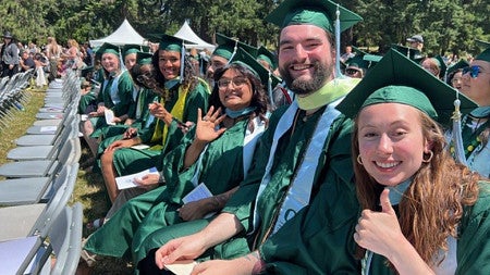 EPoL graduates smiling and waving at the camera