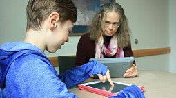image of Karrie Walters and son working on iPads