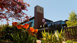 image of the UO College of Education HEDCO building with spring flowers