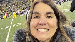 image of Jen Doty, PhD facing camera taken at a UO Ducks football game