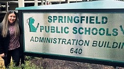 Jocelyn Sanchez standing by Springfield Public Schools sign