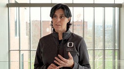 Audrey Lucero standing in front of a window speaking to a camera