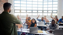 teacher standing in a classroom filled with adult students