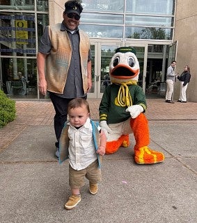 Kevin Simmons and son Mahaison (BooBoo), and the Duck at UO Graduation festivities 2024