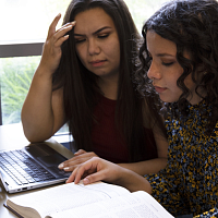 two students working on a laptop in HEDCO Learning Commons