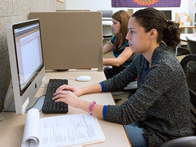 A woman working at a computer A woman working at a computer