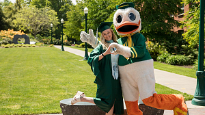 The Oregon Duck with a COE graduating student