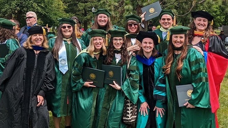 students and faculty membesr on graduation day