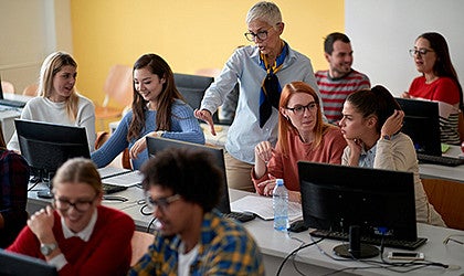 professor teaching college students in a classroom