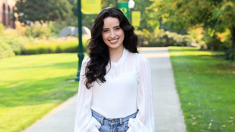 Ed Foundations student Valeria Cortes in front of HEDCO building