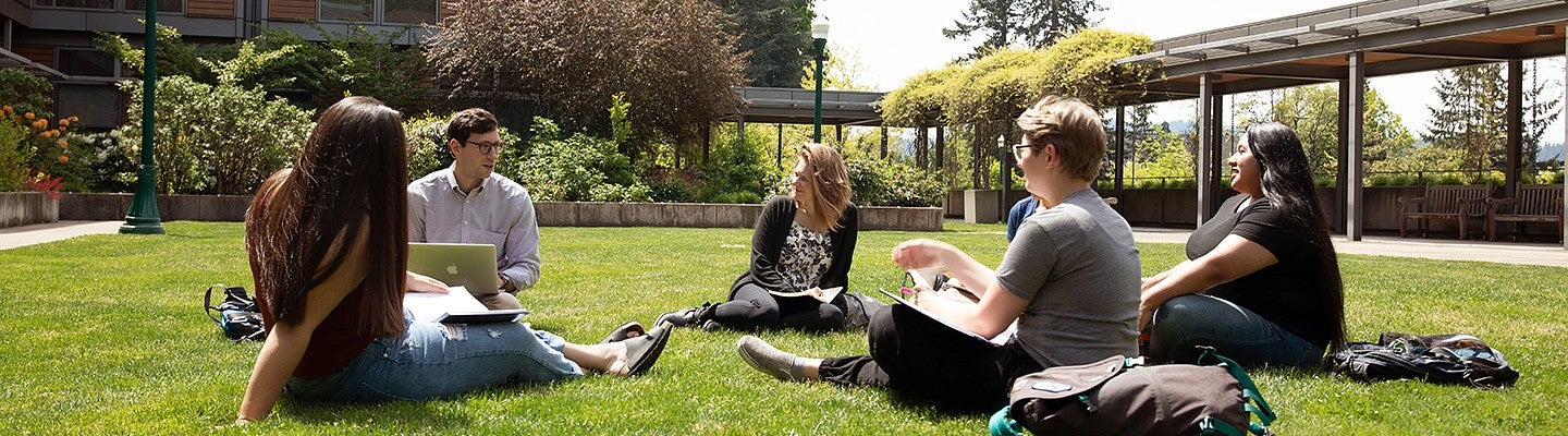 University of Oregon College of Education students sitting in HEDCO courtyard outside