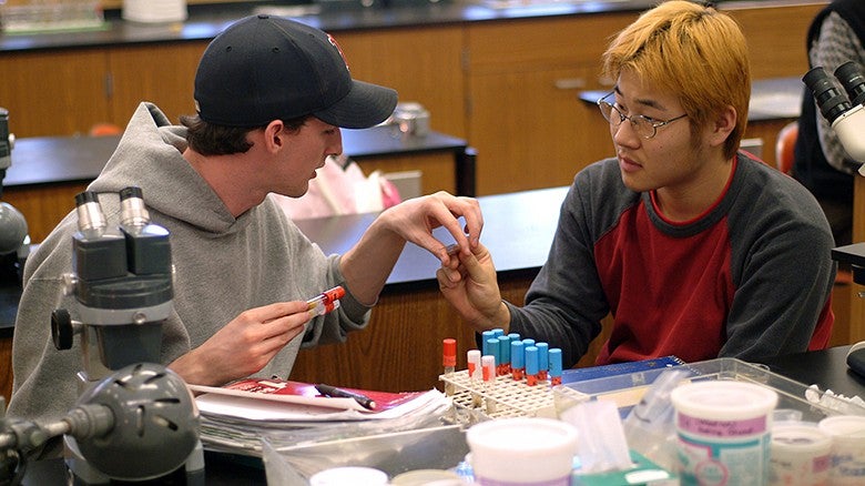University of Oregon College of Education students at a table conducting research