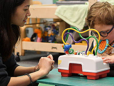 University of Oregon College of Education SPED student with child University of Oregon College of Education SPED student with child