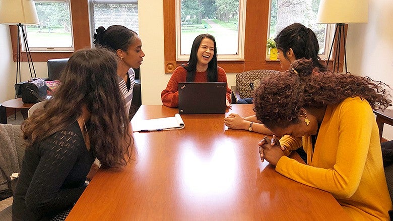 University of Oregon College of Education SOURCE group in a meeting laughing University of Oregon College of Education SOURCE group in a meeting laughing