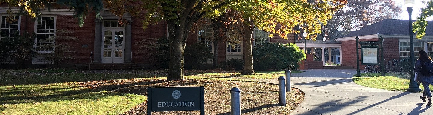 University of Oregon College of Education students walking outside HEDCO building