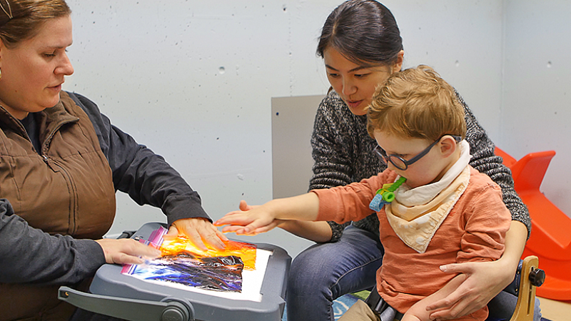 University of Oregon College of Education SPED student with professor and child University of Oregon College of Education SPED student with professor and child